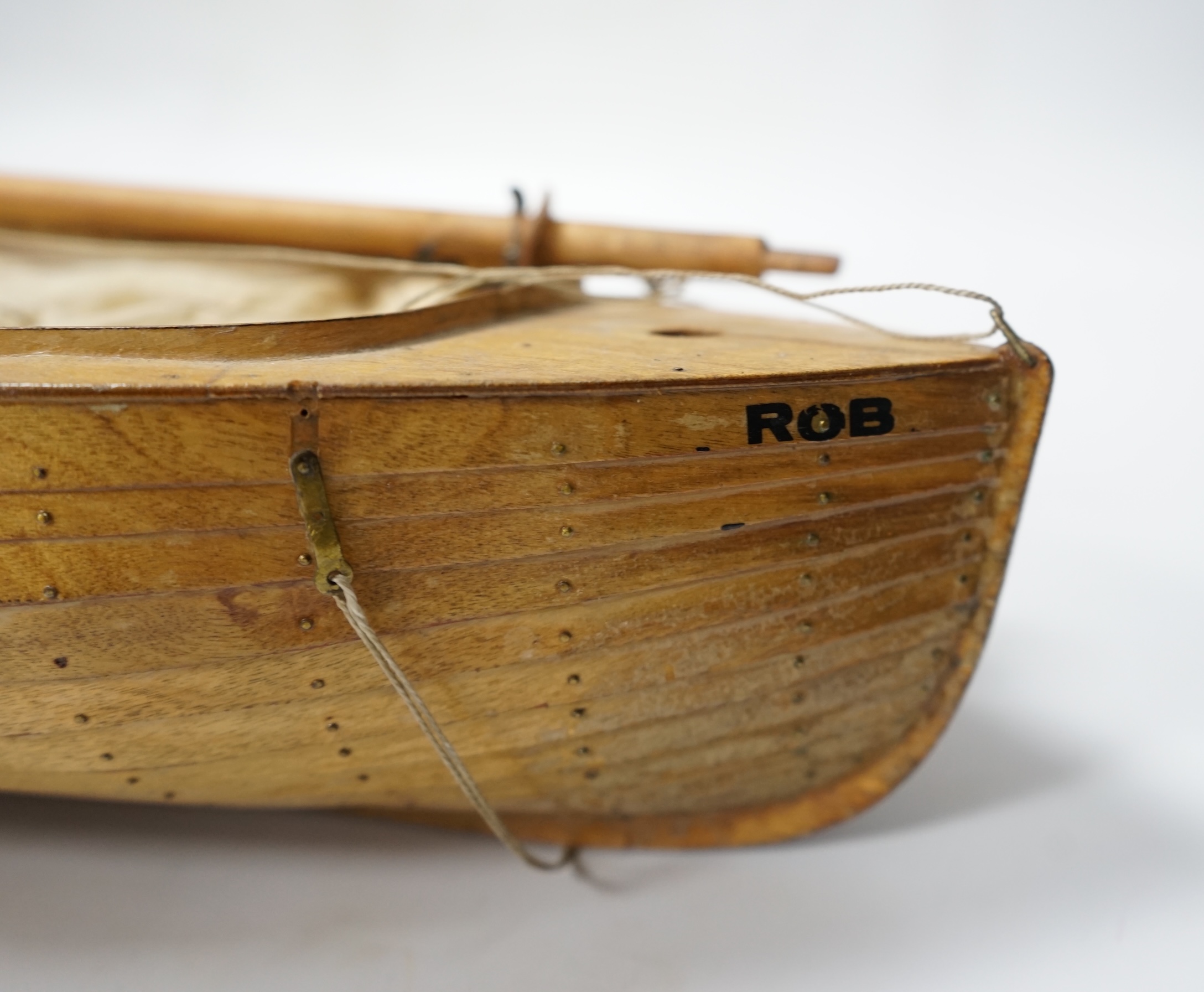 A mid 20th century kit built wooden model sailing boat, ‘Rob’, of plank on frame construction with white painted interior, hull 45cm long. Condition - fair to good.